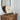 Bird Artist Board on a dark wood easel on top of a dresser in a bedroom.
