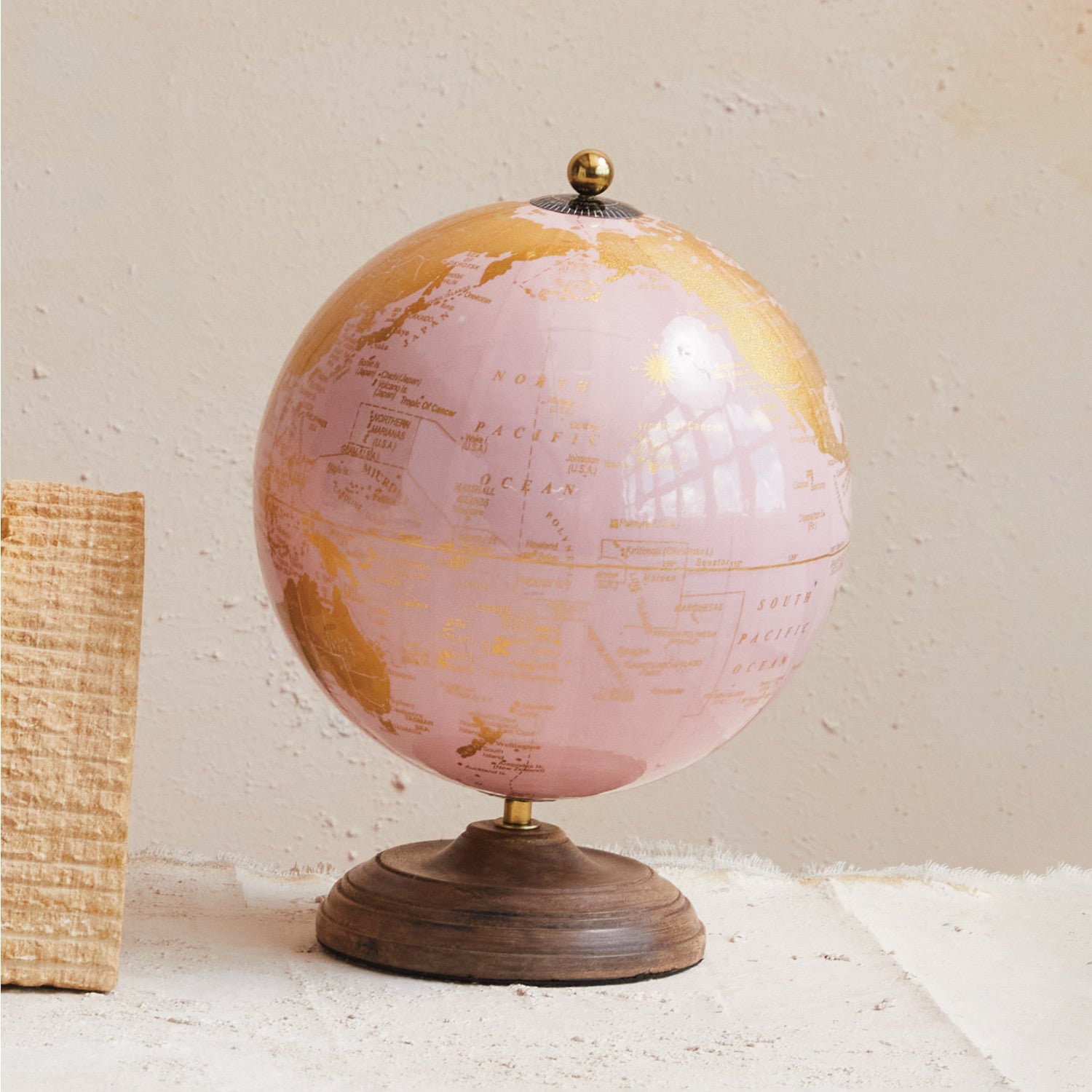 Pretty in pink and gold is this globe on a mango wood stand. 