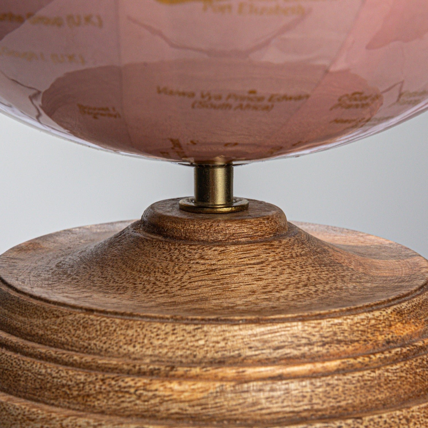 Mango wood base of the pink & gold world globe in a natural finish. 
