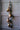 Four rustic iron bells on a jute rope strung to an antique door.