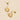 Gold hoop earrings on a beige background