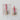 Decorative bells with red ribbons on vintage books against a textured white background.