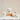 Three white mugs with Christmas designs on a white surface with marshmallows.
