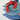 Red lobster shaped pillow with fringe detailing resting on stacked blue and green pillows.