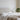 Lifestyle shot with the bed dressed in neutral linens and cozy decor.