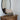 Mountain Pine Artist Board sitting on a dark wood easel in a bedroom on an antique dresser.