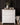White dresser - painted using Fusion Mineral Pain Snowdrop - with decorative items against a dark paneled wall.