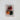 Colorful bell ornaments on a piece of paper on top of a textured surface.