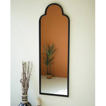 Antique black iron mirror with arched top.