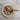Decorative bowl styled with miscellaneous items.