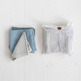 Folded Dish towels pictured beside cotton bag that set comes in