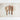Flat lay of three handcrafted Doussie wood spoons on a textured, neutral-toned background. The set includes a solid scoop-style spoon, a long and narrow serving spoon, and a slotted spoon. One spoon is partially filled with small white grains. The warm wood tones contrast with the soft, organic backdrop.