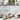 A styled kitchen scene featuring a collection of earthy-toned vintage reproduction mustard crocks, ceramic bowls, woven baskets, and decorative elements. The crocks are displayed on a marble countertop with fresh produce, a wooden spoon, and glassware, creating a warm and rustic aesthetic.