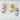 A set of three handcrafted fabric animal dolls featuring a rabbit, a pig, and an elephant, each nestled inside pastel-colored tulip-shaped pouches with floral details. They are displayed on vintage book pages against a textured white surface.