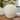 Large konos vase on wood table in entryway.