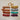 Multiple different colors of 70-75 Yard Recycled Torn Silk Ribbon in a terracotta color