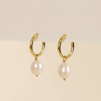 Classic pearl drop hoop earrings.