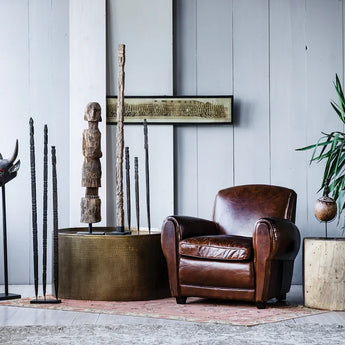 Set of planting sticks styled with similar woodwork and a leather chair.