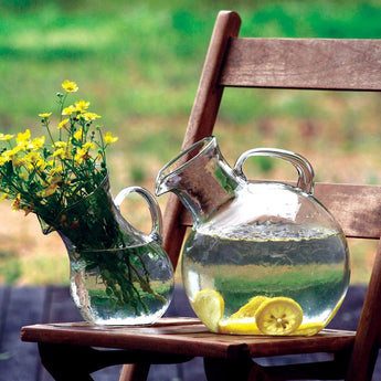 Small Mouthed Circular Tilted Pitcher containing lemon water