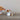 A quaint footed dish shaped like a mushroom, featuring a reactive glaze in vibrant red and white filled with assorted treats.
