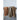 Three woven throw blankets draped over a dark wooden rail, each in earthy tones with a soft, textured weave. The left blanket is a warm terracotta brown, the middle one is a muted sage green, and the right one is a rich golden-brown blend. All three have subtle heathered patterns and short fringed edges, adding to their cozy and relaxed aesthetic.