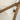 Close-up of a chair with wooden armrests and beige fabric.