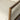 Close-up of a wooden chair leg on a textured surface