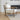 Wooden armchair with beige cushion in a living room setting