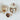 Decorative ceramic containers with acorn designs on a white surface