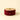Red ribbon on a cardboard spool against a beige background