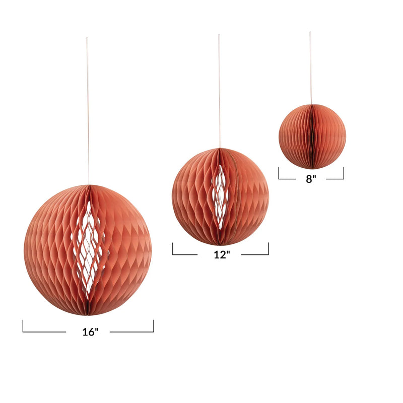 Pink paper honeycomb ornaments shown in 3 sizes. 