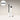 White mascara tube with black wand on a beige background, featuring 'Women's Health' logo.