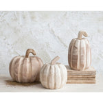 Creative Coop Set of 3 carved pumpkins on table.