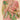 Model wearing a Floral Jungle Kimono Jacket in Petal, a lightweight, open-front jacket with a peach-toned base and a botanical print featuring green leaves and flowers. The model is smiling and crossing her arms, styled with a white top and neutral-colored pants against a soft beige background.