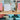 Collection of colorful affirmation cards on a wooden stand with a neutral background