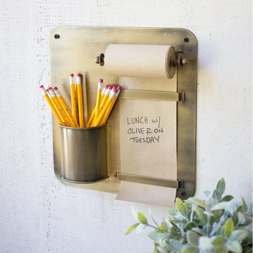 Antique Brass Hanging Note Roll and Pencil Cup mounted on a wall with pencils and a hand written bote.