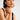 Woman wearing a black tank top with a plain background