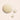Close-up of three droplets of a light-colored liquid on a beige background