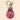 Beaded keyring in the shape of a ladybird, featuring intricate hand-stitched beadwork in red, blue, gold, and pink. The design includes floral embroidery details on the wings, a metallic gold body, and a blue beaded head with two small antennae. Attached to a gold-toned keyring and lobster clasp, displayed against a soft beige background.