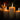 Candlelight scene with lit candles against a dark background