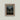 Vintage-style art print of a glowing-eyed black cat sitting on an old wooden fence at dusk, framed in gold.