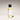 Body serum bottle with black cap and white label on a gradient background