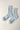 Pair of light blue socks with yellow stripes and 'Lebon Shoppe' branding on a beige background
