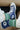 Blue Converse high-top sneakers with white laces and green socks worn indoors.