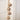 String of Brass Finish Bells on a jute rope hanging from a door. 