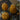 Three orange  pumpkin-shaped candles on a wood surface with an open magazine underneath the candles. 