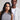 Two people standing side by side against a plain background