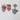 Colorful heart-shaped coasters on a textured white surface