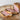 Sliced beef wellington on a wooden board with a white background