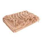 Woven Cotton Throw with Crochet and Fringe in pink laying flat on store display. 